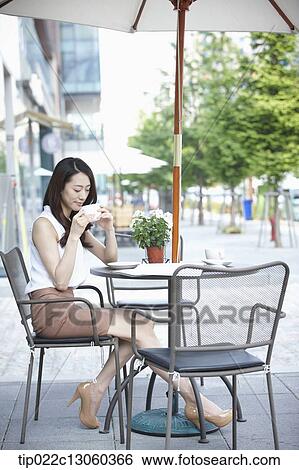 Stock Photograph - a woman drinking coffee. Fotosearch