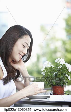 Stock Photography - a woman drinking coffee. Fotosearch