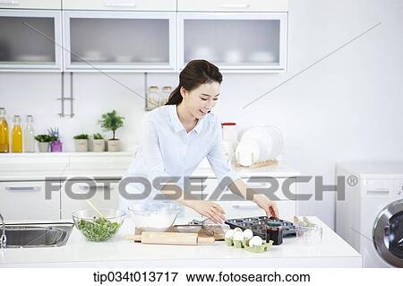a woman getting preparation for cupcakes View Large Photo Image Stock Photo - a woman getting preparation for cupcakes. Fotosearch