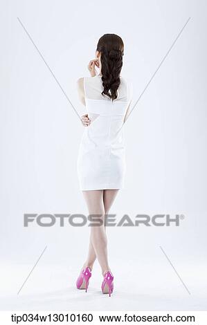 a woman in a white dress facing other way View Large Photo Image Stock Image - a woman in a white dress facing other way. Fotosearch