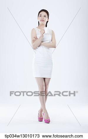 Stock Image - a woman in a white dress facing other way. Fotosearch