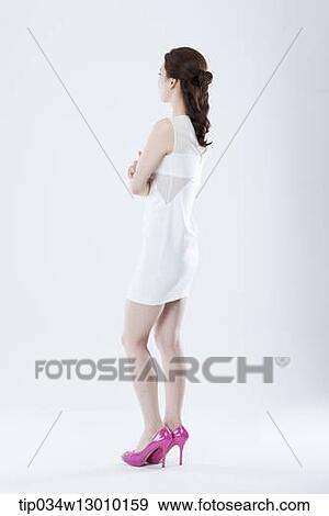 a woman in a white dress facing other way View Large Photo Image Stock Photo - a woman in a white dress facing other way. Fotosearch