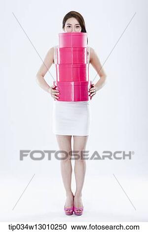 a woman in a white dress holding pink boxes View Large Photo Image Stock Image - a woman in a white dress holding pink boxes. Fotosearch