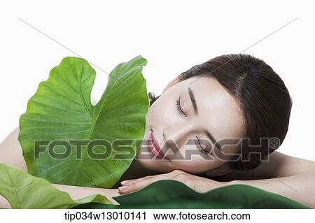 Stock Image - a woman in a white dress posing. Fotosearch