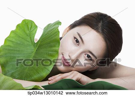 Stock Image - a woman in a white dress posing. Fotosearch