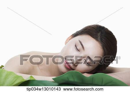 Stock Image - a woman in a white dress posing. Fotosearch