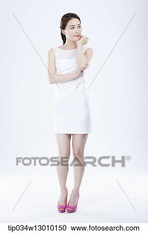 Stock Image - a woman in a white dress posing. Fotosearch
