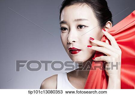 a woman in red lipstick posing with red curtain View Large Photo Image Stock Image - a woman in red lipstick posing with red curtain. Fotosearch