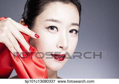 a woman in red lipstick posing with red curtain View Large Photo Image Stock Photo - a woman in red lipstick posing with red curtain. Fotosearch