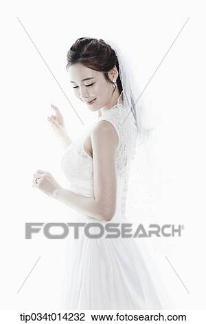 Stock Image - a woman in wedding dress in white background. Fotosearch