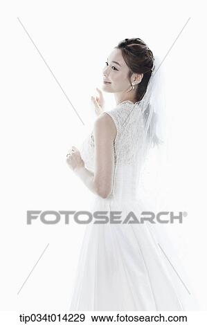 Stock Photo - a woman in wedding dress in white background. Fotosearch