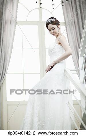 a woman in wedding dress standing on the stairs View Large Photo Image Stock Image - a woman in wedding dress standing on the stairs. Fotosearch