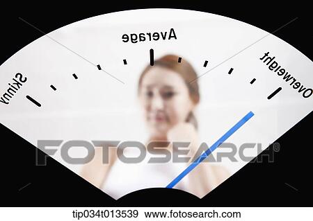 a woman in weighing scale View Large Photo Image Stock Photo - a woman in weighing scale. Fotosearch
