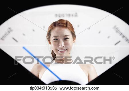Stock Photography - a woman in weighing scale. Fotosearch