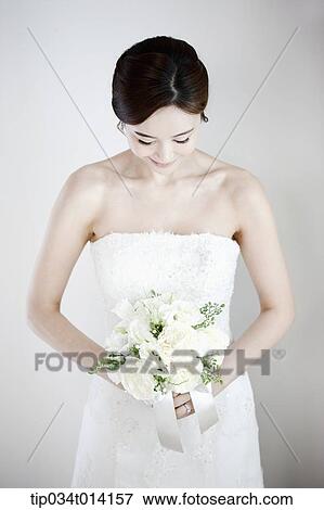 Stock Photo - a woman posing with wedding dress on. Fotosearch
