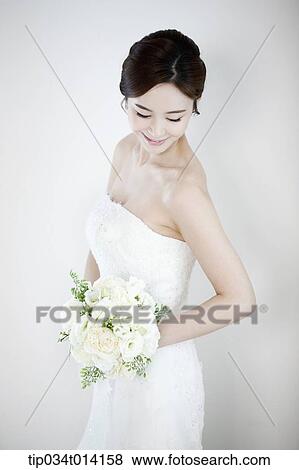 a woman posing with wedding dress on View Large Photo Image Stock Photo - a woman posing with wedding dress on. Fotosearch