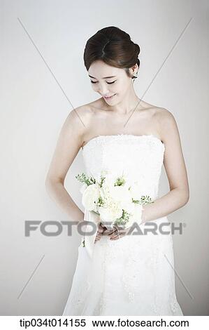a woman posing with wedding dress on View Large Photo Image Stock Photography - a woman posing with wedding dress on. Fotosearch