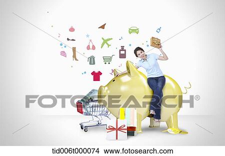 a woman sitting on a golden piggy bank View Large Photo Image Picture - a woman sitting on a golden piggy bank. Fotosearch