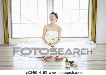 a woman sitting on the floor with wedding dress on View Large Photo Image Stock Image - a woman sitting on the floor with wedding dress on. Fotosearch