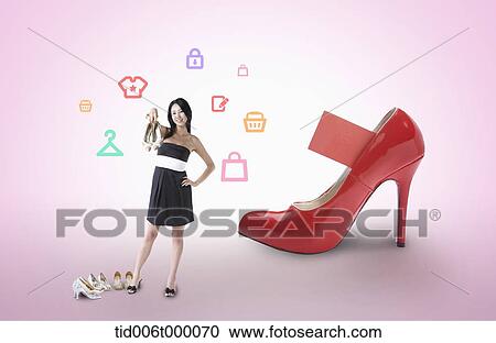 Stock Image - a woman standing in front of a high heel. Fotosearch