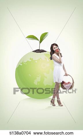 a woman standing next to the globe View Large Photo Image Picture - a woman standing next to the globe. Fotosearch