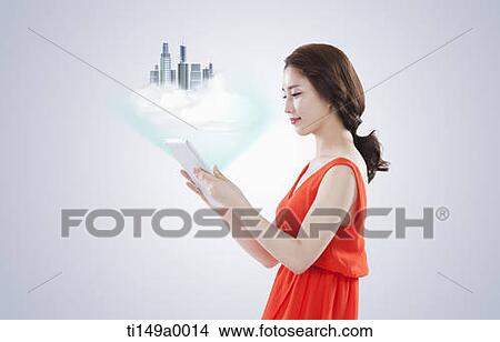 a woman using a tablet PC View Large Photo Image Picture - a woman using a tablet PC. Fotosearch