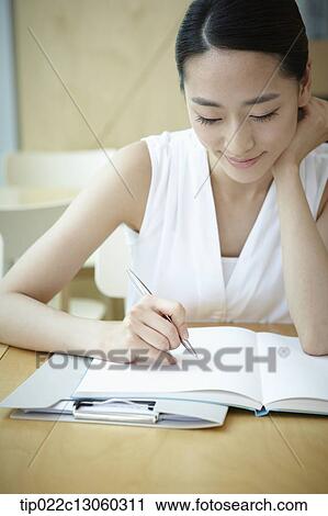 a woman with a white shirt working View Large Photo Image Stock Image - a woman with a white shirt working . Fotosearch