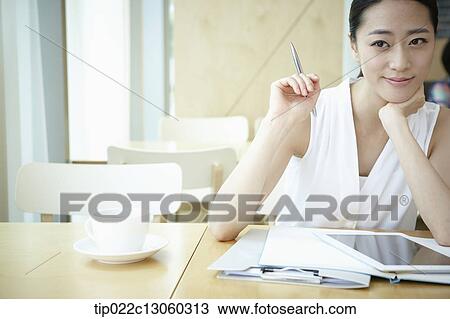 a woman with a white shirt working View Large Photo Image Stock Image - a woman with a white shirt working . Fotosearch