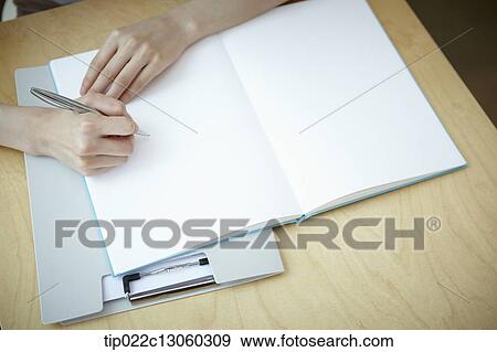 Stock Photo - a woman with a white shirt working . Fotosearch