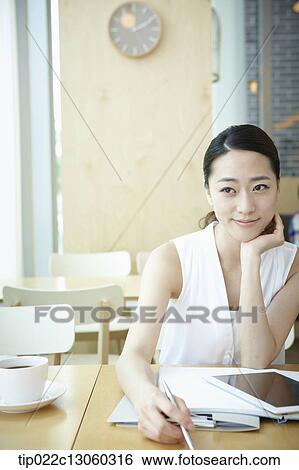 Stock Photograph - a woman with a white shirt working . Fotosearch