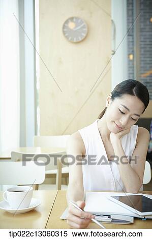 a woman with a white shirt working View Large Photo Image Stock Photography - a woman with a white shirt working . Fotosearch