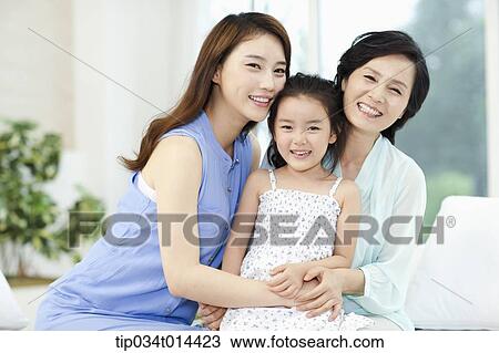 a woman with daughter and grand daughter on a couch View Large Photo Image Stock Image - a woman with daughter and grand daughter on a couch. Fotosearch