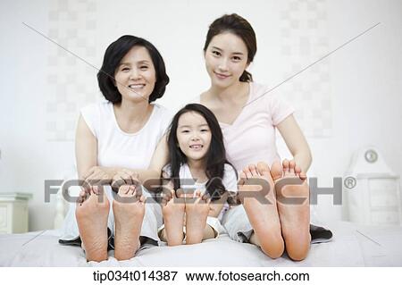 a woman with daughter and grand daughter on a bed View Large Photo Image Stock Photo - a woman with daughter and grand daughter on a bed. Fotosearch