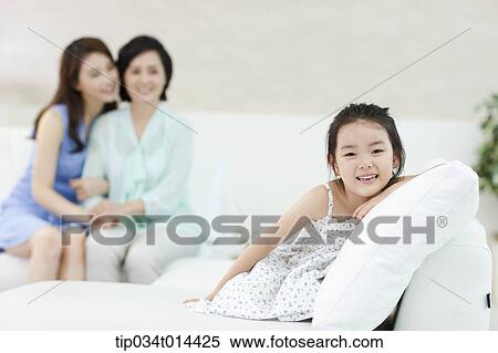 Stock Photography - a woman with daughter and grand daughter in the room. Fotosearch
