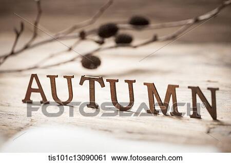 Stock Image - a word autumn on a wood surface. Fotosearch