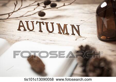 a word autumn on a wood surface with an open book View Large Photo Image Stock Photo - a word autumn on a wood surface with an open book. Fotosearch