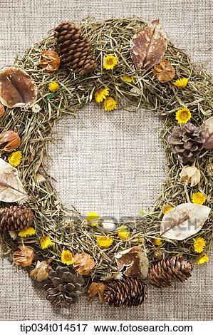 Stock Photo - a wreath with autumn leaves and nuts . Fotosearch