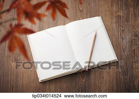 an open book on wooden surface View Large Photo Image Picture - an open book on wooden surface. Fotosearch