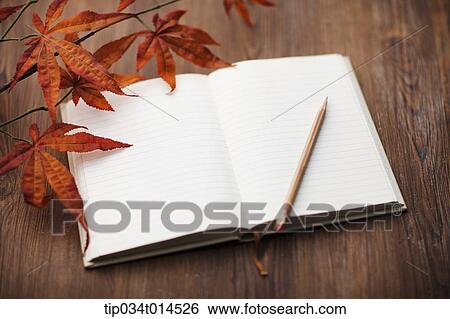 Stock Photograph - an open book on wooden surface. Fotosearch