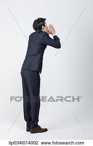 Stock Image - back shot of a businessman shouting. Fotosearch
