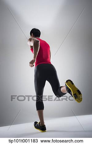 Stock Image - back shot of a runner running. Fotosearch