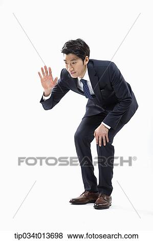 Stock Photo - businessman bending down to say hello. Fotosearch