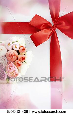 Stock Image - close up shot of a box with ribbon and flowers. Fotosearch