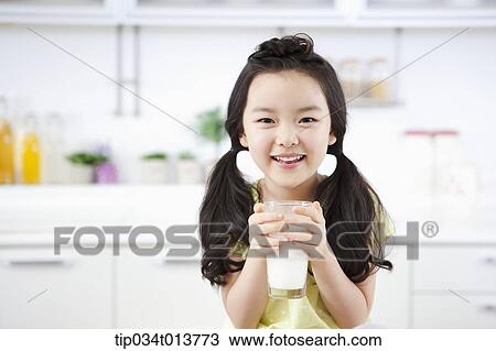 Stock Image - close up shot of a kid with a glass of milk. Fotosearch