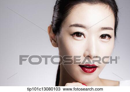 Stock Image - close up shot of a woman in red lipsticks. Fotosearch
