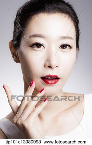 Stock Photo - close up shot of a woman in red lipsticks and white top. Fotosearch