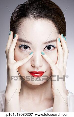 Stock Photo - close up shot of a woman in red lipsticks and white top. Fotosearch