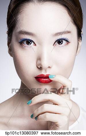 Stock Photo - close up shot of a woman in red lipsticks. Fotosearch