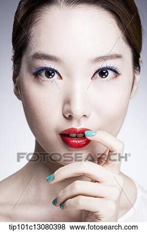 Stock Photo - close up shot of a woman in red lipsticks. Fotosearch