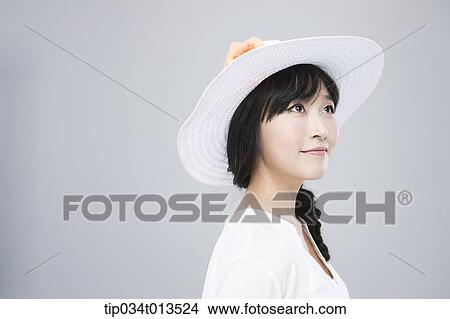 close up shot of a woman in white hat posing View Large Photo Image Picture - close up shot of a woman in white hat posing . Fotosearch